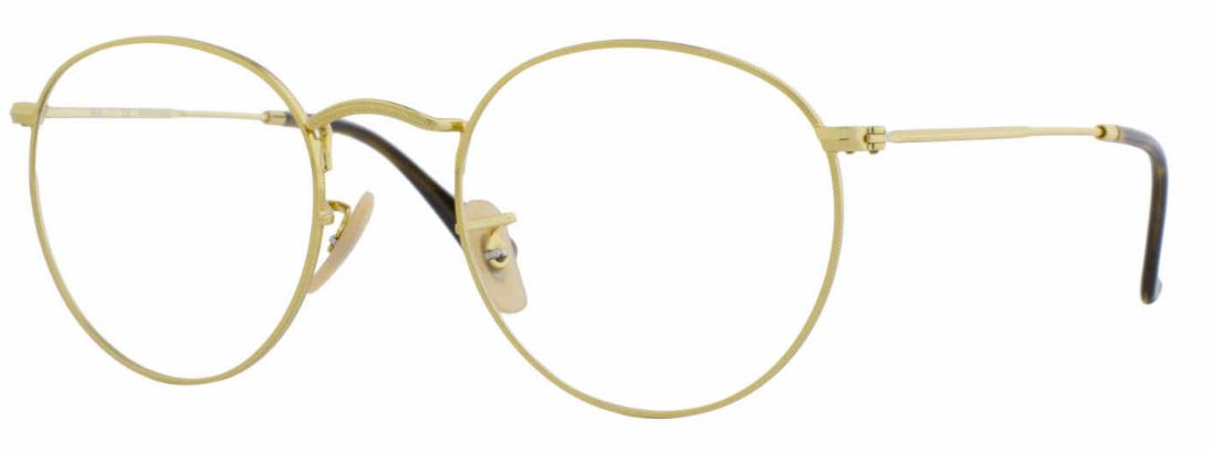 Close-up of vintage gold-rimmed eyeglasses with nose pads.